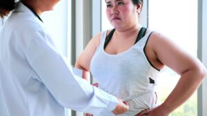 female-doctor-measuring-worried-chubby-woman